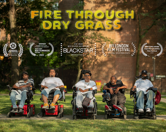 Image of the Fire Through Dry Grass film promotion poster. Five poets face the camera in front of the Coler nursing home. They are middle aged Black and Latino men who all use wheelchairs..